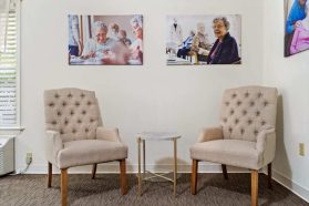 2 chairs and a table on the side of the living room