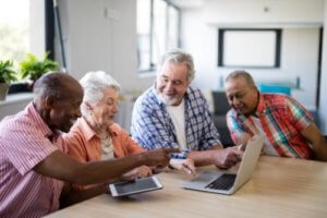 Senior citizens watching a laptop on the table