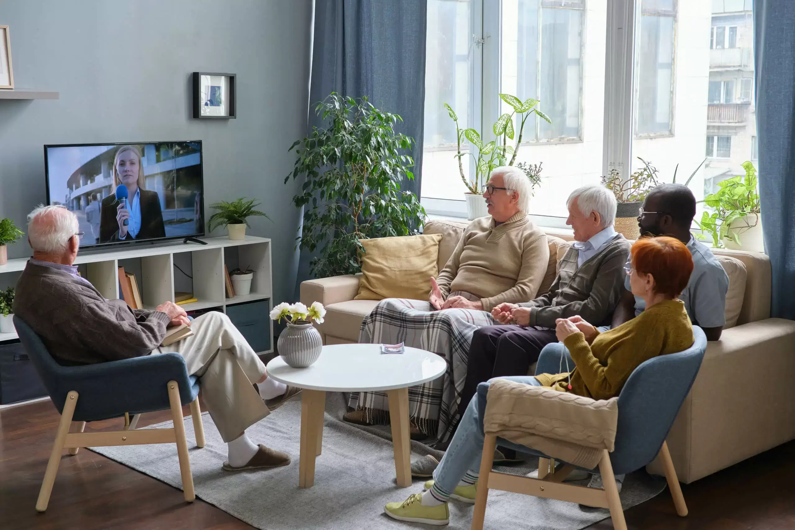 Senior citizens watching news on tv