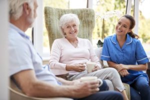 Senior couples talk with their caregiver