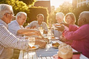 Group of senior people having picnic on park