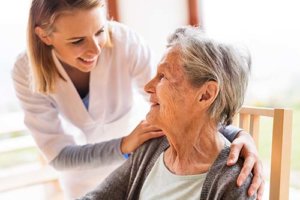 Caregiver checking old woman's health