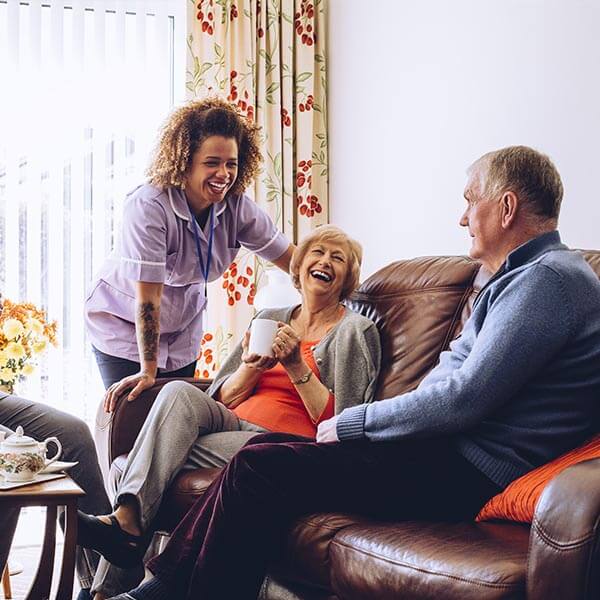 Happy senior couples talk with senior living professional