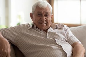 Old man enjoying sitting on the sofa