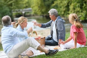 Senior citizens enjoying picnic near the river