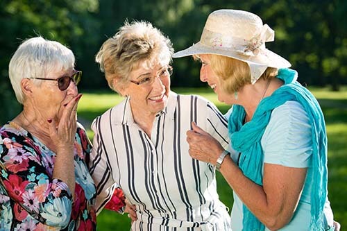 Old woman enjoying outdoor activities with her friends