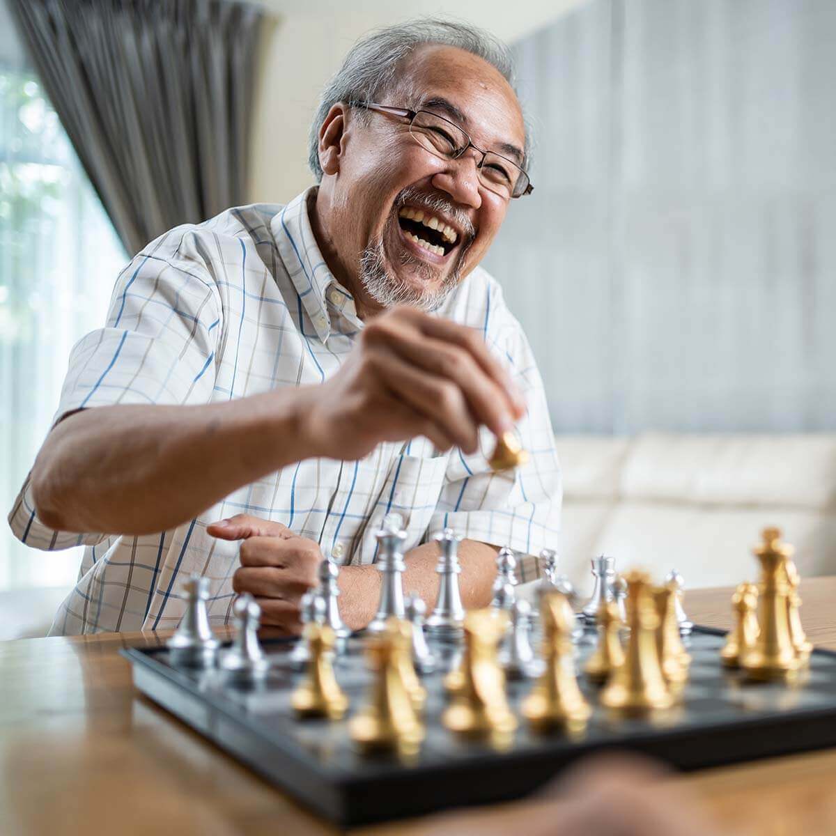 Home exceptional amenities senior playing chess with senior citizen