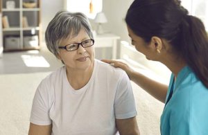 Old woman talk with her caregiver