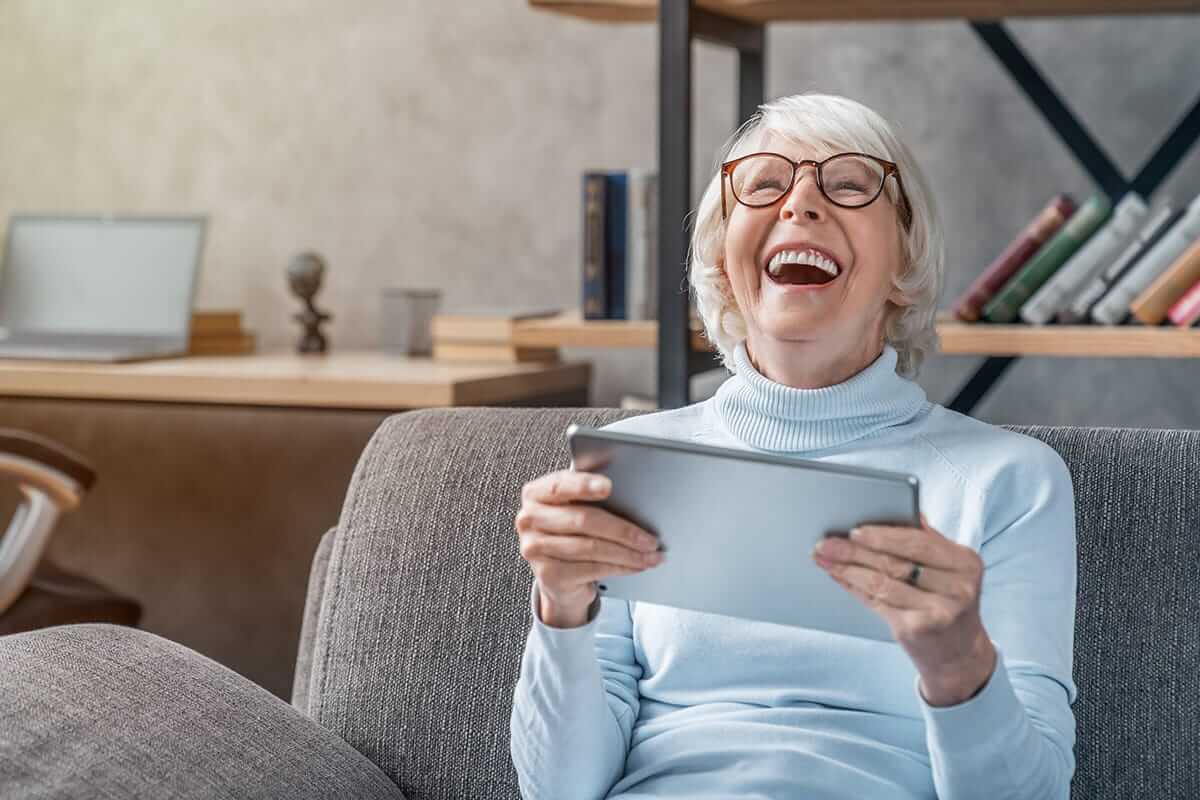 Happy old woman play his ipad