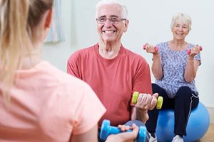 Happy senior citizens enjoying yoga exercises