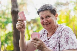 Old woman playing card game outdoor