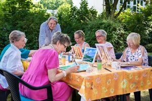 Senior citizens enjoy outdoor painting