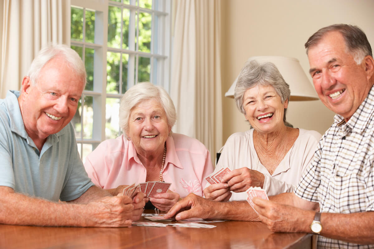 Couples Enjoying Game Of Cards